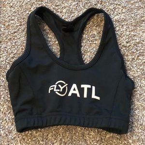 Black sports bra with Flywheel logo